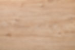 Oak wood with visible grain patterns and knots. Light brown color, creating a natural and rustic texture. No text or objects present.