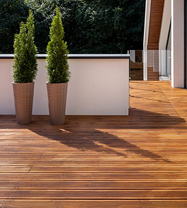 outdoor wood deck with durable and warm brown planks and patio furniture in a landscaped backyard, residential garden decking for outdoor living space